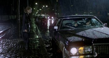 Movie still from “Ms .45” (1981), directed by Abel Ferrara – A woman standing on the side of a road next to a car; Wide shot, Low angle