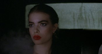 Movie still from “Ms .45” (1981), directed by Abel Ferrara – A woman with red lipstick is sitting in a car; Close Up shot, Over the shoulder angle