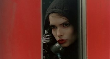 Movie still from “Ms .45” (1981), directed by Abel Ferrara – A woman in a hooded jacket talking on a phone; Close Up shot, Low angle