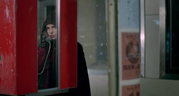 Movie still from “Ms .45” (1981), directed by Abel Ferrara – A person standing next to a window talking on a phone; Close Up shot, Over the shoulder angle
