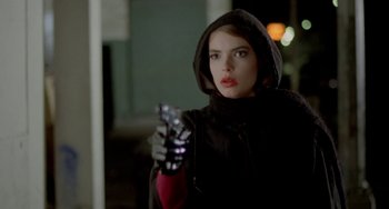 Movie still from “Ms .45” (1981), directed by Abel Ferrara – A woman in a hooded jacket holding a cell phone in her hand; Close Up shot, Low angle