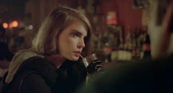 Movie still from “Ms .45” (1981), directed by Abel Ferrara – A woman sitting at a table holding a wine glass; Close Up shot, Over the shoulder angle
