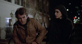 Movie still from “Ms .45” (1981), directed by Abel Ferrara – A man and a woman standing next to each other on a bench; Medium shot, Over the shoulder angle