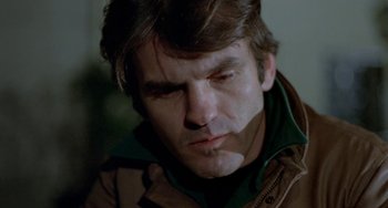 Movie still from “Ms .45” (1981), directed by Abel Ferrara – A person wearing a brown jacket; Close Up shot, Low angle