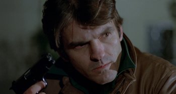 Movie still from “Ms .45” (1981), directed by Abel Ferrara – A person holding a gun; Close Up shot, Low angle