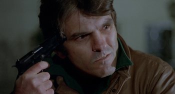 Movie still from “Ms .45” (1981), directed by Abel Ferrara – A person holding a gun; Close Up shot, High angle
