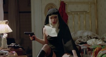 Movie still from “Ms .45” (1981), directed by Abel Ferrara – A woman dressed up as a nun holding a gun; Medium shot, High angle