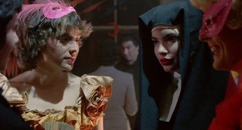Movie still from “Ms .45” (1981), directed by Abel Ferrara – Two women dressed up in costumes in front of a crowd; Close Up shot, Over the shoulder angle