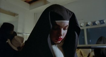 Movie still from “Ms .45” (1981), directed by Abel Ferrara – A woman in a nun's habit with a red lipstick; Close Up shot, Low angle