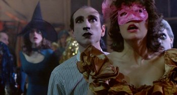 Movie still from “Ms .45” (1981), directed by Abel Ferrara – A man and a woman wearing masks in front of a crowd; Close Up shot, Low angle