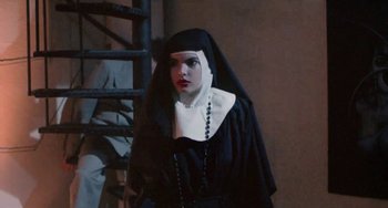 Movie still from “Ms .45” (1981), directed by Abel Ferrara – A woman dressed up as a nun in front of a ladder; Medium shot, Low angle
