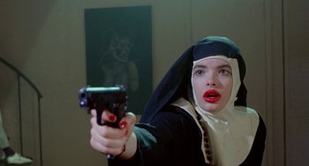 Movie still from “Ms .45” (1981), directed by Abel Ferrara – A woman dressed as a nun holding a gun; Close Up shot, Low angle
