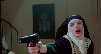 Movie still from “Ms .45” (1981), directed by Abel Ferrara – A woman dressed as a nun holding a gun; Close Up shot, Low angle