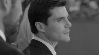 Movie still from “Much Ado About Nothing” (2012), directed by Joss Whedon – Black and white photograph of a man in a business suit; Close Up shot, Over the shoulder angle