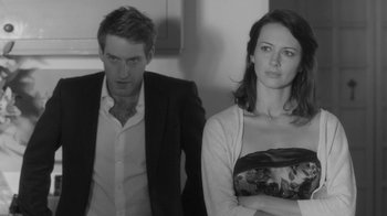Movie still from “Much Ado About Nothing” (2012), directed by Joss Whedon – A man and a woman standing next to each other; Medium shot, Over the shoulder angle