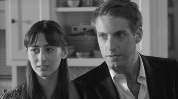 Movie still from “Much Ado About Nothing” (2012), directed by Joss Whedon – A man and a woman standing next to each other; Close Up shot, Over the shoulder angle