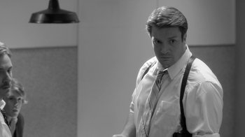 Movie still from “Much Ado About Nothing” (2012), directed by Joss Whedon – Black and white photograph of a man in a suit and suspenders; Medium shot, Over the shoulder angle