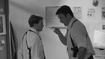 Movie still from “Much Ado About Nothing” (2012), directed by Joss Whedon – Two men in dress shirts and suspenders are talking; Medium shot, Over the shoulder angle