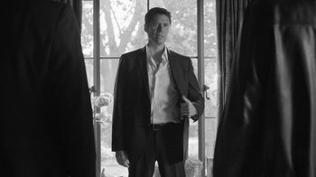 Movie still from “Much Ado About Nothing” (2012), directed by Joss Whedon – A black and white photo of a man in a suit; Medium shot, Low angle