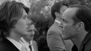 Movie still from “Much Ado About Nothing” (2012), directed by Joss Whedon – A man and a woman face each other in front of other men; Close Up shot, Over the shoulder angle