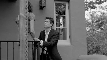 Movie still from “Much Ado About Nothing” (2012), directed by Joss Whedon – A black and white photo of a man and a woman; Medium shot, Low angle