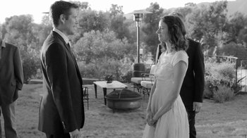 Movie still from “Much Ado About Nothing” (2012), directed by Joss Whedon – A man and a woman standing next to each other outside; Wide shot, Over the shoulder angle