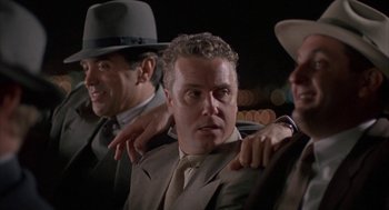 Movie still from “Mulholland Falls” (1996), directed by Lee Tamahori – A group of men in suits and hats standing next to each other; Medium shot, Over the shoulder angle