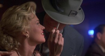 Movie still from “Mulholland Falls” (1996), directed by Lee Tamahori – A man and a woman looking at each other's hat; Close Up shot, Over the shoulder angle