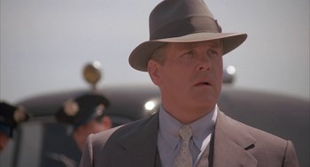 Movie still from “Mulholland Falls” (1996), directed by Lee Tamahori – A man in a suit and a hat; Close Up shot, Low angle