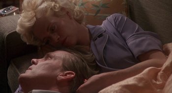 Movie still from “Mulholland Falls” (1996), directed by Lee Tamahori – A man and a woman laying on a bed; Close Up shot, Low angle