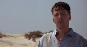 Movie still from “Mulholland Falls” (1996), directed by Lee Tamahori – A person standing on a beach; Close Up shot, Low angle