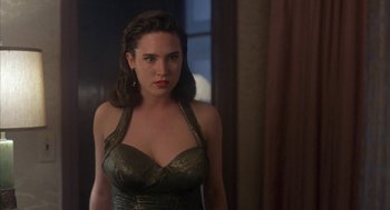 Movie still from “Mulholland Falls” (1996), directed by Lee Tamahori – A woman in a green dress standing in front of a window; Close Up shot, Over the shoulder angle