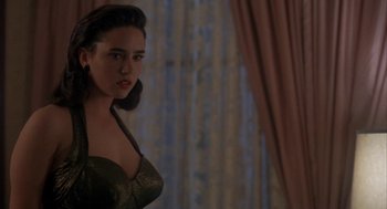Movie still from “Mulholland Falls” (1996), directed by Lee Tamahori – A woman in a green dress standing in front of a window; Close Up shot, Over the shoulder angle