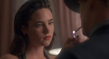 Movie still from “Mulholland Falls” (1996), directed by Lee Tamahori – A woman is looking into the mirror while a man is lighting a cigarette; Close Up shot, Over the shoulder angle