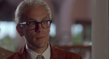 Movie still from “Mulholland Falls” (1996), directed by Lee Tamahori – An older man wearing glasses and an orange jacket; Close Up shot, Low angle