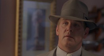 Movie still from “Mulholland Falls” (1996), directed by Lee Tamahori – A person wearing a suit and a hat; Close Up shot, Over the shoulder angle