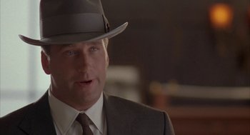 Movie still from “Mulholland Falls” (1996), directed by Lee Tamahori – A person wearing a suit and a hat; Close Up shot, Low angle