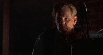 Movie still from “Mulholland Falls” (1996), directed by Lee Tamahori – A person wearing a suit and tie; Close Up shot, Low angle