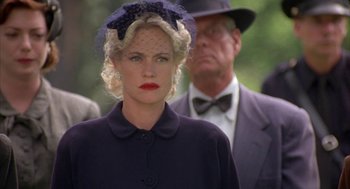 Movie still from “Mulholland Falls” (1996), directed by Lee Tamahori – A woman in a black coat with a veil on her head; Close Up shot, Low angle