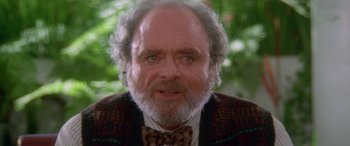 Movie still from “Multiplicity” (1996), directed by Harold Ramis – An older man with a beard and a bow tie; Close Up shot, Over the shoulder angle