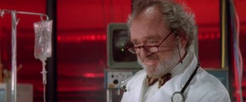 Movie still from “Multiplicity” (1996), directed by Harold Ramis – An older man wearing glasses and a lab coat; Close Up shot, Low angle