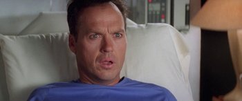 Movie still from “Multiplicity” (1996), directed by Harold Ramis – A person sitting in a hospital bed; Close Up shot, Low angle