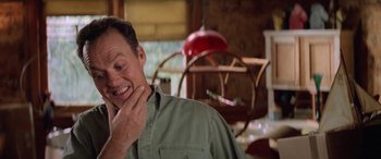 Movie still from “Multiplicity” (1996), directed by Harold Ramis – A man smiles while holding his hand to his face; Close Up shot, Low angle