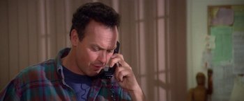Movie still from “Multiplicity” (1996), directed by Harold Ramis – A person talking on a cell phone; Close Up shot, Low angle