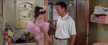 Movie still from “Multiplicity” (1996), directed by Harold Ramis – A man and a little girl are holding hands in a room; Medium shot, Over the shoulder angle