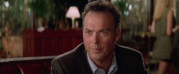 Movie still from “Multiplicity” (1996), directed by Harold Ramis – A person wearing a suit and tie; Close Up shot, Over the shoulder angle