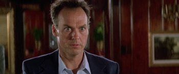 Movie still from “Multiplicity” (1996), directed by Harold Ramis – A person wearing a suit and tie; Close Up shot, Low angle