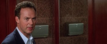 Movie still from “Multiplicity” (1996), directed by Harold Ramis – A man in a suit and tie in a bathroom; Close Up shot, Low angle