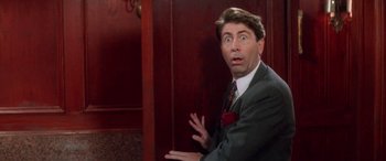 Movie still from “Multiplicity” (1996), directed by Harold Ramis – A person wearing a suit and tie; Close Up shot, Overhead angle