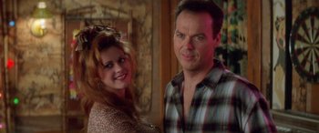 Movie still from “Multiplicity” (1996), directed by Harold Ramis – A man and a woman pose for a picture; Close Up shot, Over the shoulder angle